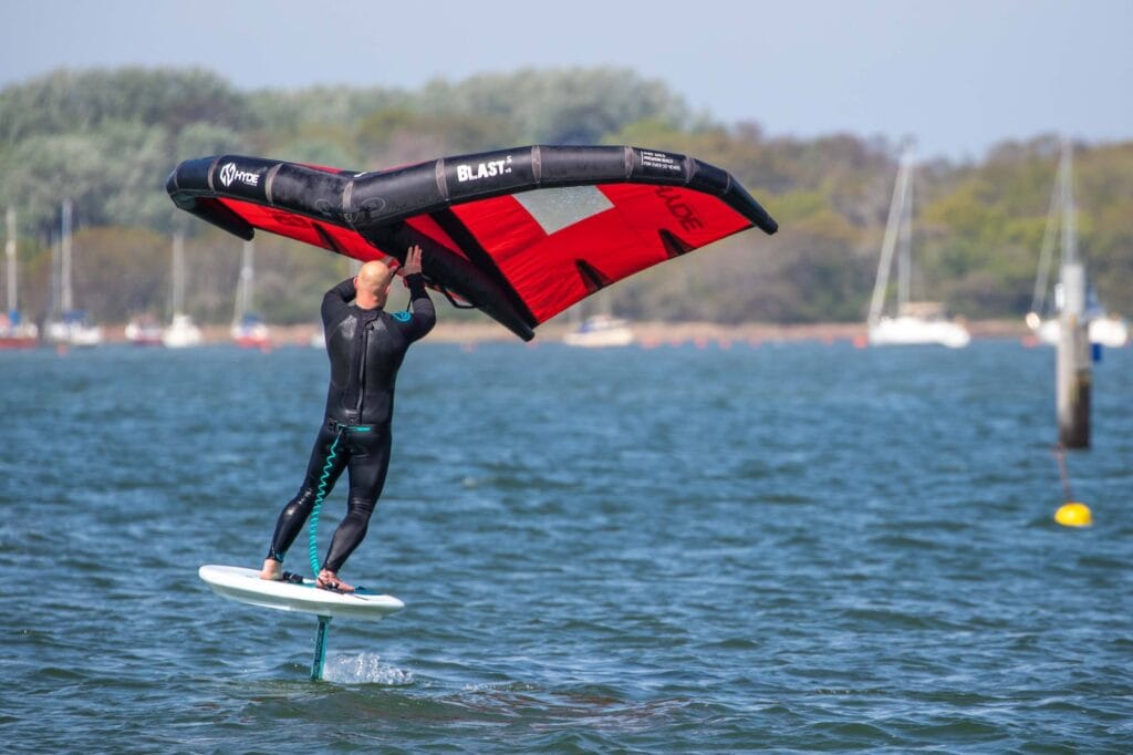 Wing-Foiling im Sonnenschein auf flachem Wasser